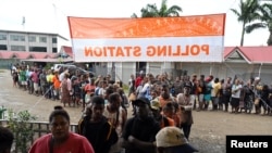 Voters queue at a polling station to vote during the national election in the capital Honiara, Solomon Islands, April 17, 2024. 