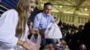 Republican presidential candidate Mitt Romney holds bags of food as he participates in a campaign event collecting supplies from residents local relief organizations for victims of superstorm Sandy in Kettering, Ohio, Tuesday, Oct. 30, 2012.