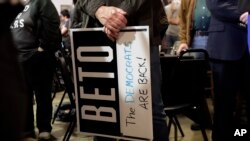 A supporter of senate hopeful Beto O'Rourke holds a sign during a Democratic watch party following the Texas primary election, Tuesday, March 6, 2018, in Austin, Texas. 