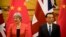 British Prime Minister Theresa May, left, and Chinese Premier Li Keqiang attend a signing ceremony at the Great Hall of the People in Beijing, Wednesday, Jan. 31, 2018. 