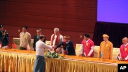 緬甸總統吳登盛在首都內比都主持了由電視轉播的停火協議簽署儀式後與與會者握手。