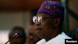 Schoolchildren pose for a picture with Tokyo 2020 Olympic Games&#39; robot-type mascot Miraitowa during a ceremony at Hoyonomori elementary school in Tokyo, Japan.
