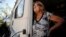 Janelle Crosby stands in a donated recreational vehicle where she has lived with her husband since Hurricane Michael in Springfield, Fla., May 1, 2019. Crosby fears the beginning of hurricane season.