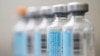 FILE - Vials of flu vaccine.