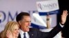 Republican presidential candidate Mitt Romney, right, and his wife Ann wave to a crowd in Schaumburg, Illinois, after Romney won the Illinois Republican presidential primary, March 20, 2012.