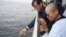 In this photo provided by the Shenyang Municipal Information Office, Liu Xia, the wife of Chinese Nobel Peace Prize laureate Liu Xiaobo, watches as Liu's ashes are buried at sea off the coast of Dalian in northeastern China's Liaoning Province, July 15, 2