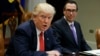 Treasury Secretary Steven Mnuchin listens as President Donald Trump speaks during a meeting on the Federal budget, Feb. 22, 2017, in the Roosevelt Room of the White House in Washington.