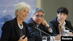 International Monetary Fund managing director Christine Lagarde (L) speaks at a news conference at the Treasury in London, May 22, 2012. 