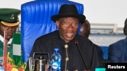 Inmates stand on the roof of the penitentiary in Cascavel, Parana state, Brazil. Inmates rioting for better facilities in the jail killed four fellow prisoners, decapitating two of them, and took two guards hostage, officials said.