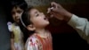 A health worker gives a polio vaccine to a girl in Lahore, Pakistan, April 9, 2018. A Pakistani official said authorities launched a new polio vaccination drive, aiming to reach 38.7 million children younger than 5.
