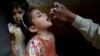 A health worker gives a polio vaccine to a girl in Lahore, Pakistan, April 9, 2018. A Pakistani official said authorities launched a new polio vaccination drive, aiming to reach 38.7 million children younger than 5.