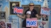 Stephen Kimel and his wife Greta Kimel attract costumers to take pictures at their photo booth which was set-up at a street festival for convention goers ahead of the Democratic National Convention in Charlotte, North Carolina, September 3, 2012. 
