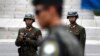 In this April 17, 2017, file photo, two North Korean soldiers look at the south side as a South Korean soldier, center, standing guard at the border village of Panmunjom which has separated the two Koreas since the Korean War, South Korea. South Korea's 