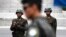 In this April 17, 2017, file photo, two North Korean soldiers look at the south side as a South Korean soldier, center, standing guard at the border village of Panmunjom which has separated the two Koreas since the Korean War, South Korea. South Korea's 