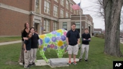 Teacher Kelly Gasior, left, and students, from left, Olivia Mashtaire, Ryan Lysek, Christian Vazquez and Tyler Lysek stand with a statue of a Buffalo that's been emblazoned with anti-bullying messages outside Lorraine Academy, Public School No. 72, in Buf