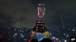 Chile's goalkeeper Claudio Bravo lifts the Copa America trophy after defeating Argentina in the final soccer match at the National Stadium in Santiago, Chile, Saturday, July 4, 2015. Chile became Copa America champions for the first time after defeating A