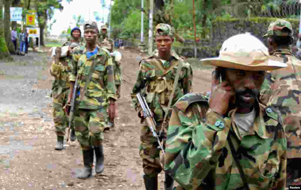 Congolese Revolution Army rebels walk down a street in Goma, soon after capturing the city from the government army, November 20, 2012.