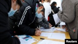 ບັນດາຜູ້ຊອກຫາວຽກງງານ ໄປຢ້ຽມຢາມຢູ່ແຕ່ລະໂຕະ ໃນງານມະຫະກໍາວຽກງານໃນນະຄອນຫຼວງປັກກິ່ງ, ຈີນ, ວັນທີ 16 ກຸມພາ 2023. 