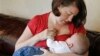 FILE - Jessica Ewald breast-feeds her 5-month-old son, Bennett, at her home in Oakbrook Terrace, Ill., Sept. 14, 2011.
